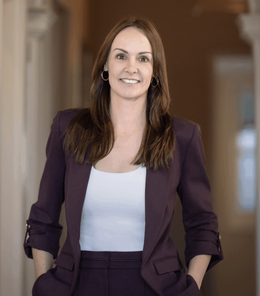 Photo of a woman in professional attire holding a folder